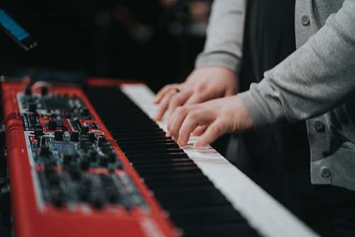 musical instrument person playing red and white piano piano